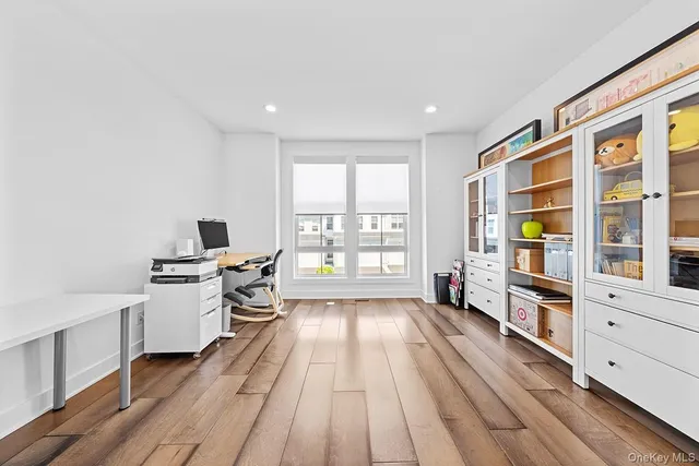 a kitchen with a wooden floor and white appliances