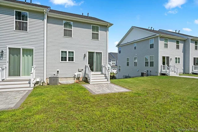 a view of a house with backyard and porch