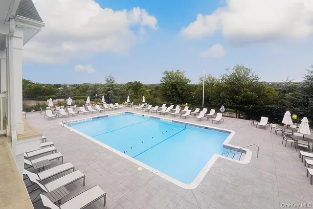 a view of a swimming pool with lounge chairs
