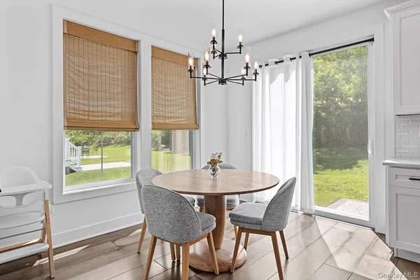 a dining room with furniture and window