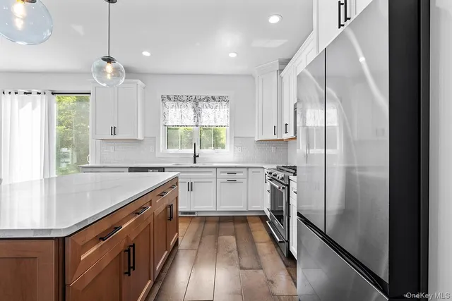 a kitchen with refrigerator cabinets and a sink