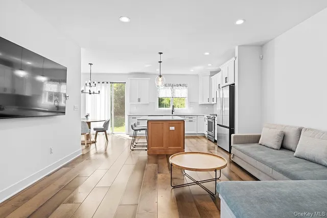 a kitchen with stainless steel appliances a dining table chairs and kitchen view