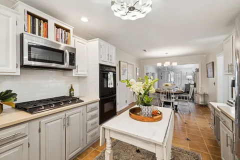 a kitchen with stainless steel appliances a microwave a stove and cabinets
