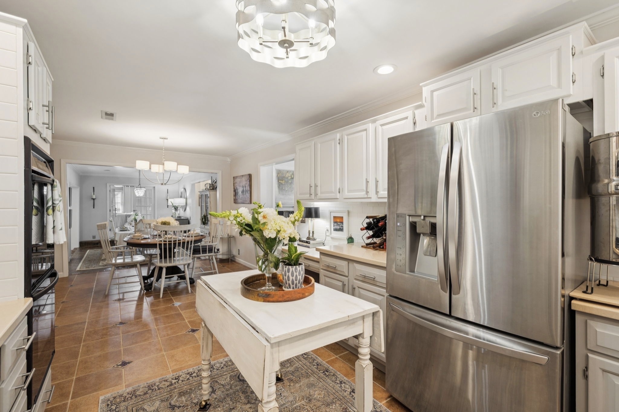 121 Pebble View Drive Franklin, TN 37064 - Photo 13 of 49 a kitchen with a refrigerator a sink dishwasher a dining table and chairs with wooden floor