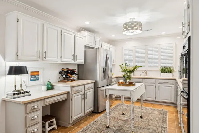 a kitchen with stainless steel appliances kitchen island granite countertop a sink stove and refrigerator