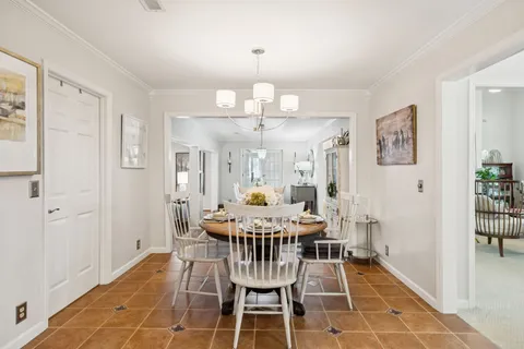 a view of a dining room with furniture wooden floor and chandelier