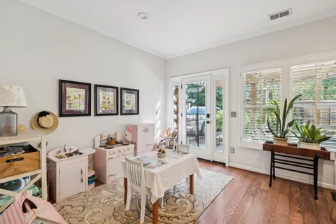 a living room with furniture and wooden floor