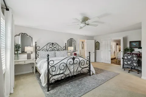 a bedroom with furniture and a chandelier