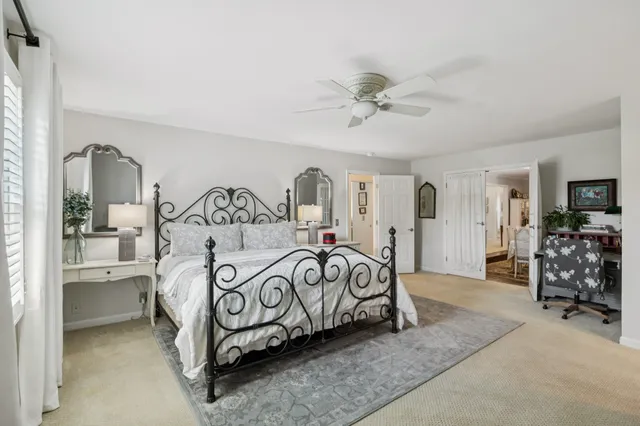 a bedroom with furniture and a chandelier