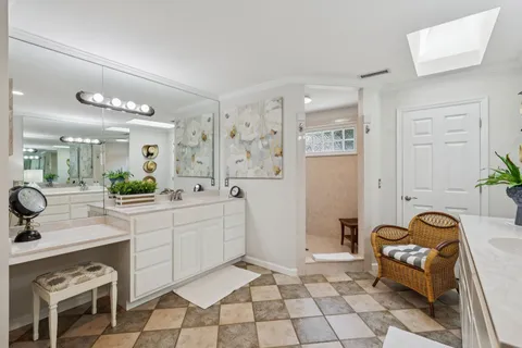 a spacious bathroom with a tub sink and mirror