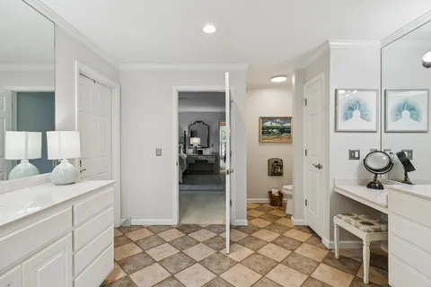 a spacious bathroom with a granite countertop sink and a mirror