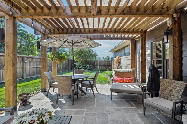 a view of a patio with table and chairs and potted plants