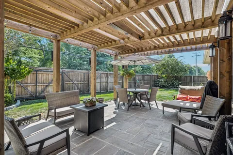 a view of house with backyard and patio