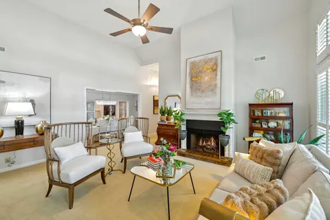 a living room with furniture a fireplace with a flat screen tv