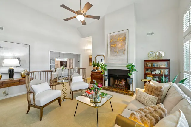 a living room with furniture a fireplace with a flat screen tv