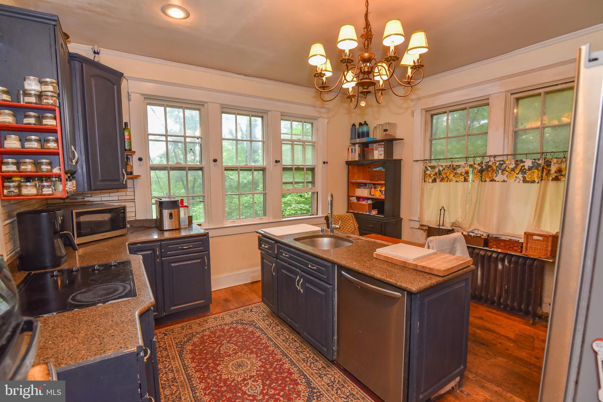 24 Merrymount Road Baltimore, MD 21210 - Photo 7 of 48 a kitchen with a stove a sink dishwasher and a flat screen tv
