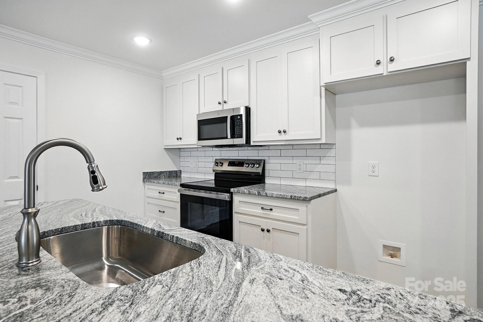 251 Lincoln Road York, SC 29745 - Photo 12 of 30 a kitchen with granite countertop a sink stainless steel appliances and cabinets