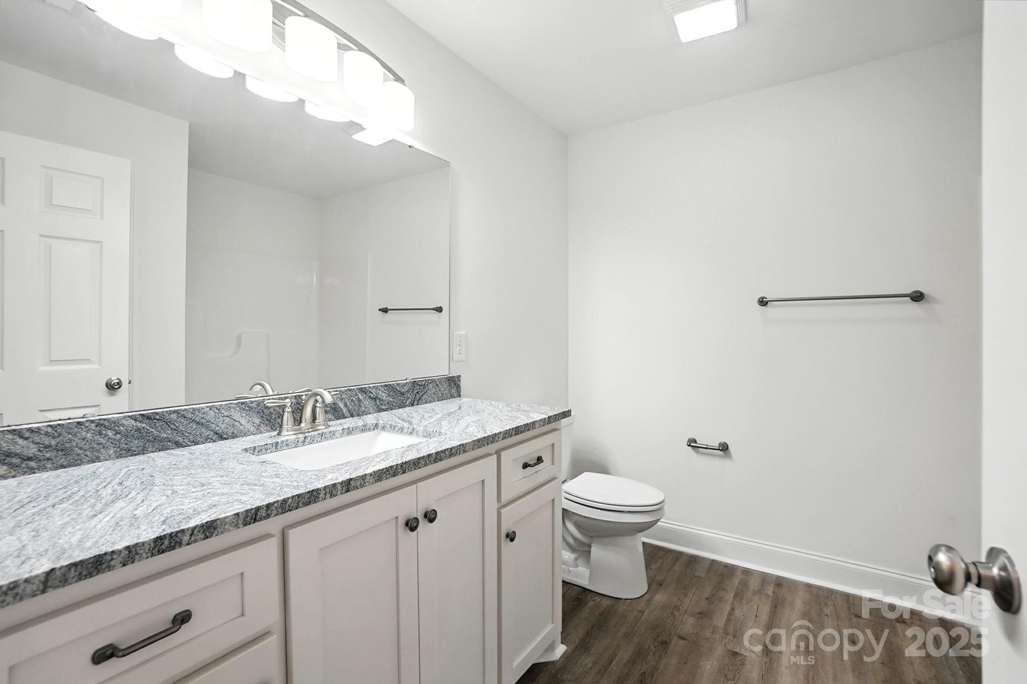 251 Lincoln Road York, SC 29745 - Photo 22 of 30 a bathroom with a granite countertop sink a toilet and a mirror