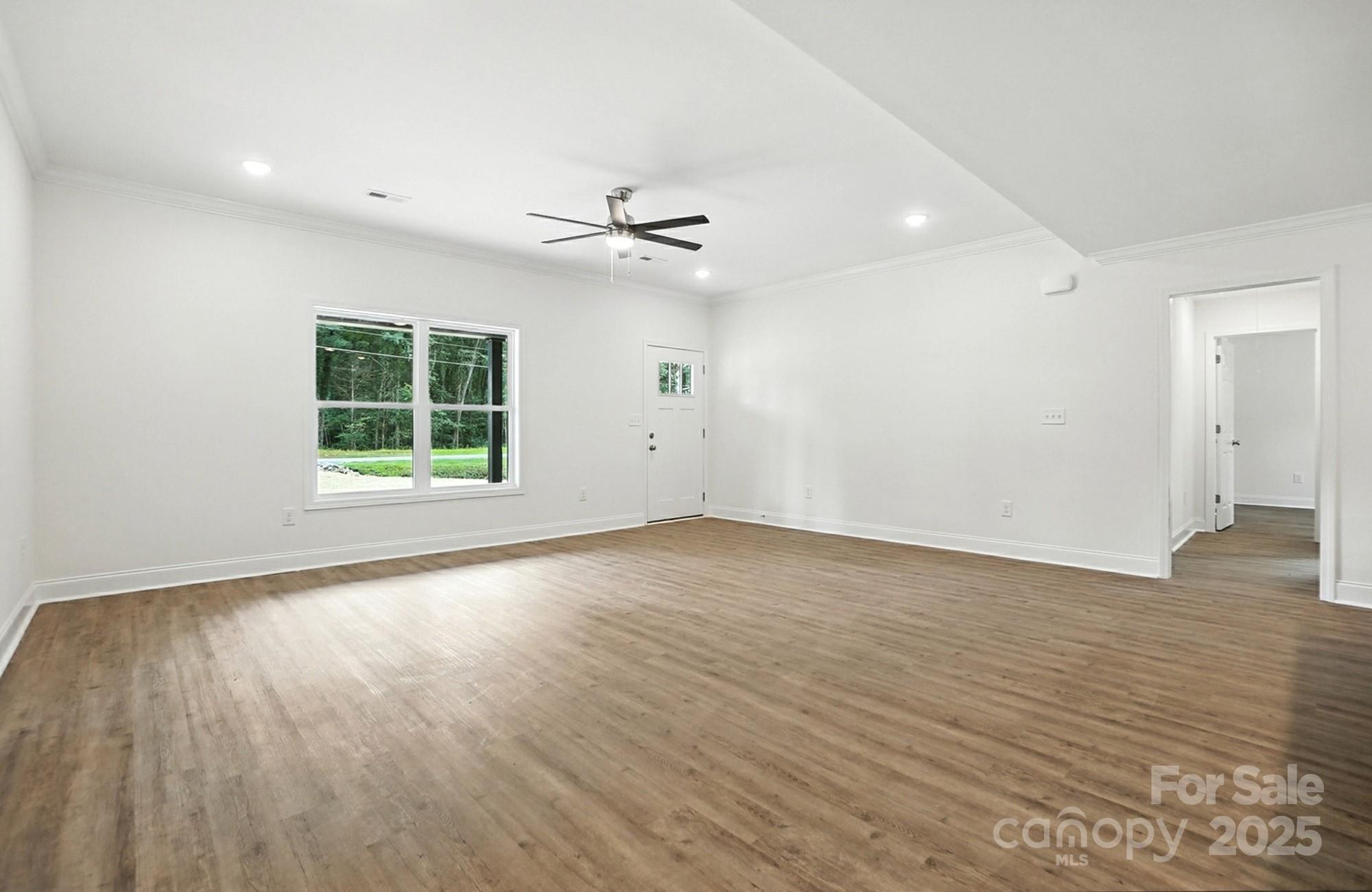 251 Lincoln Road York, SC 29745 - Photo 5 of 30 an empty room with wooden floor and windows