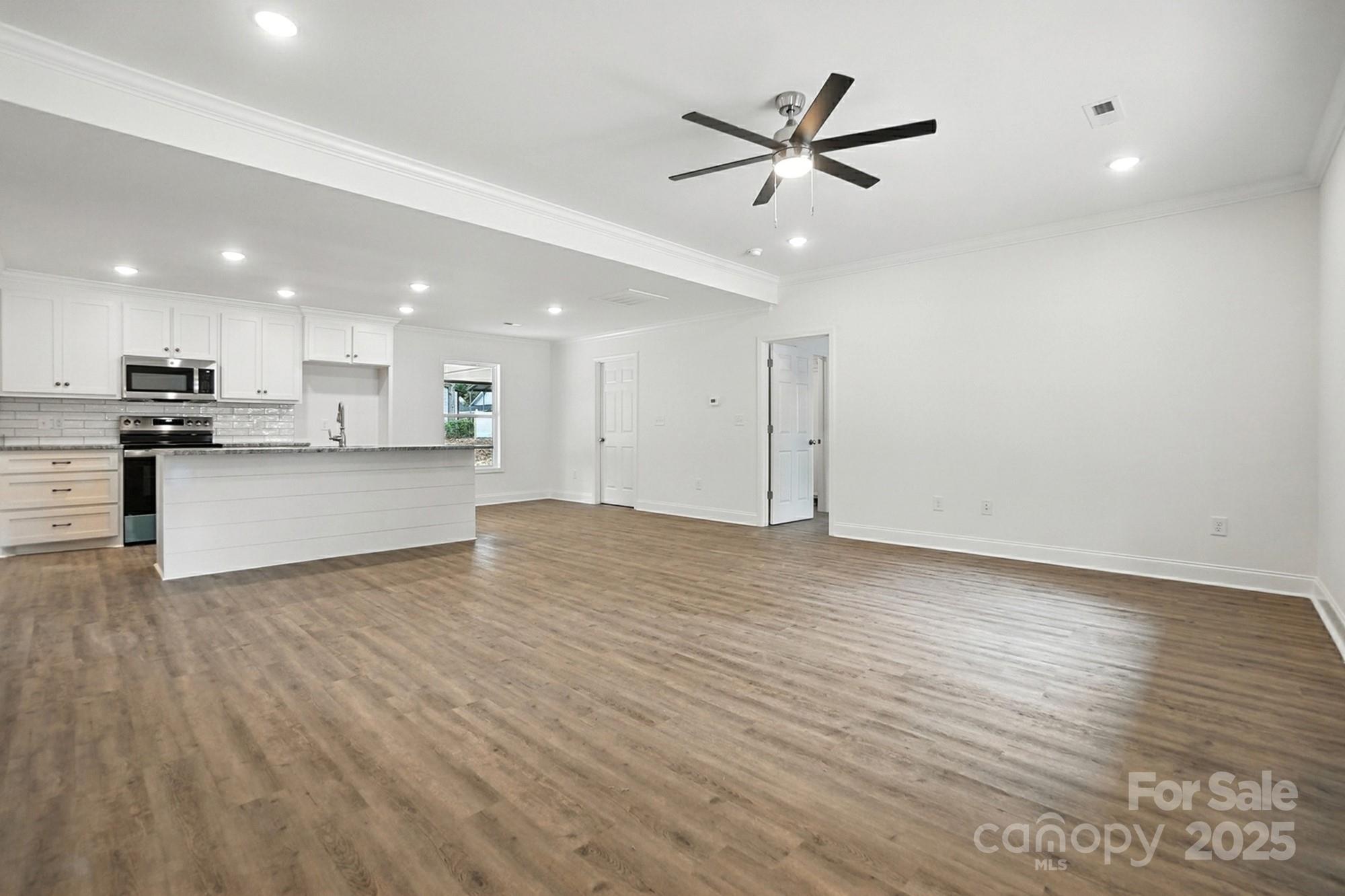 251 Lincoln Road York, SC 29745 - Photo 7 of 30 a view of a kitchen with a sink and wooden floor