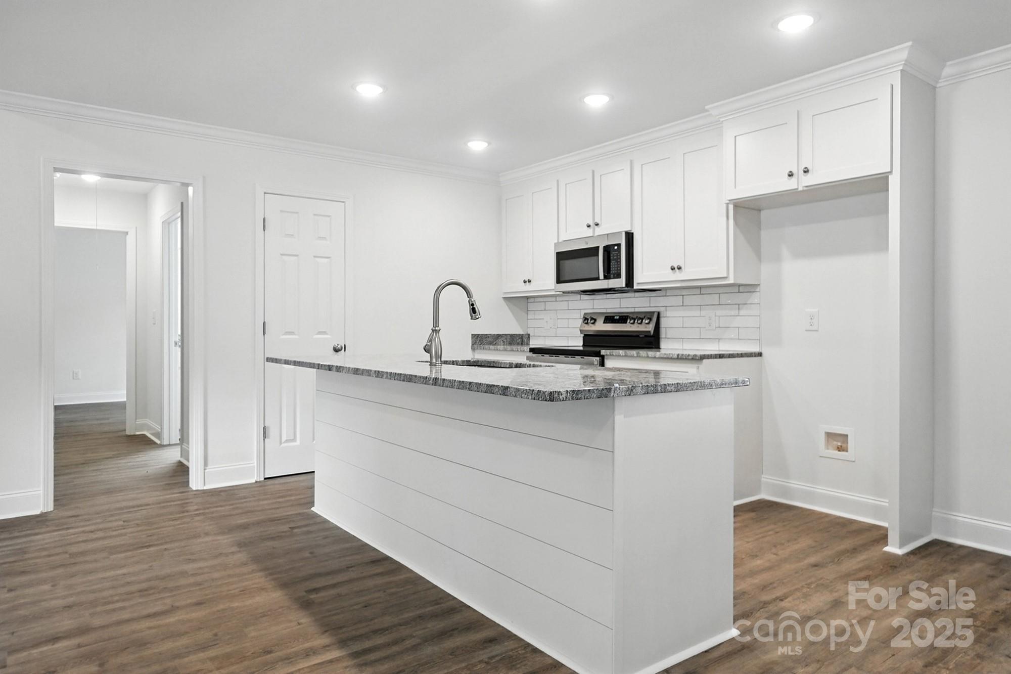 251 Lincoln Road York, SC 29745 - Photo 10 of 30 a kitchen with kitchen island a sink stainless steel appliances and cabinets