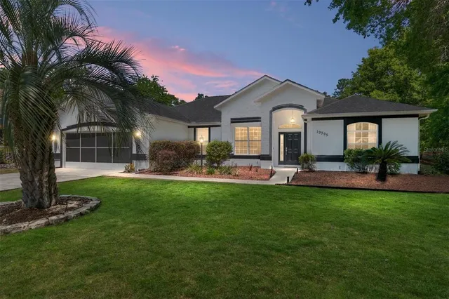 a front view of a house with a garden and patio