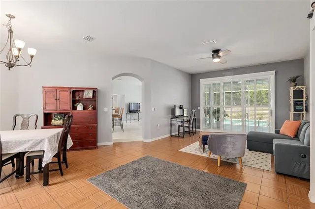 a living room with furniture and a floor to ceiling window