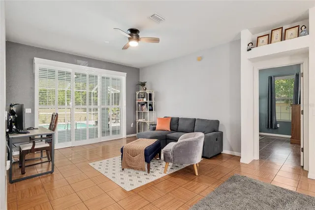 a living room with furniture a dining table and a rug