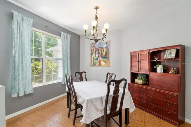 a living room with stainless steel appliances kitchen island granite countertop furniture and a large window