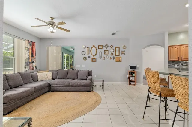 a living room with furniture and kitchen view