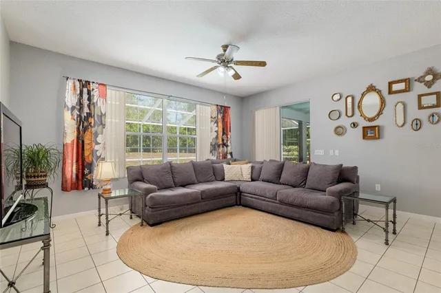 a living room with furniture and a view of kitchen
