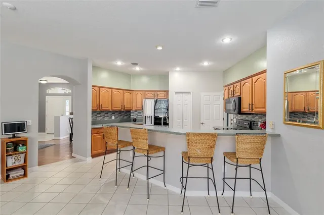 a kitchen with stainless steel appliances granite countertop a stove sink and microwave