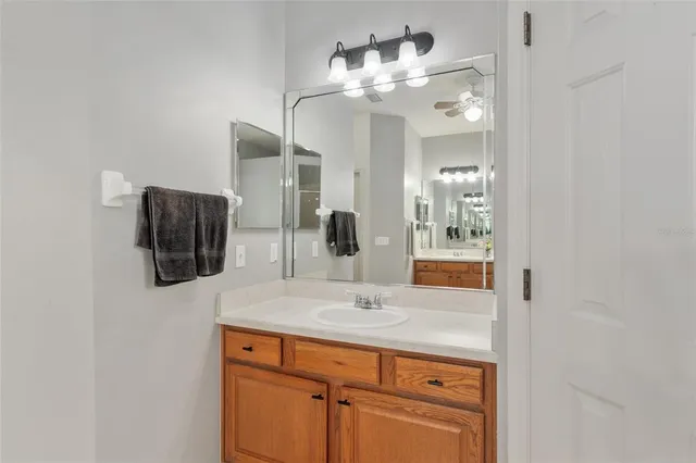 a bedroom with bed and a flat tv screen on dresser