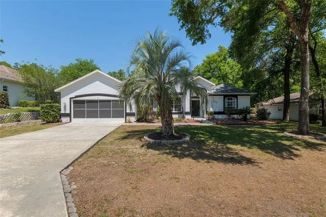 a front view of a house with yard and porch