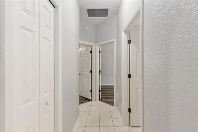 a dining room with furniture and a potted plant