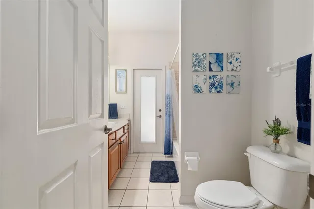 a view of a patio with table and chairs with wooden floor and fence
