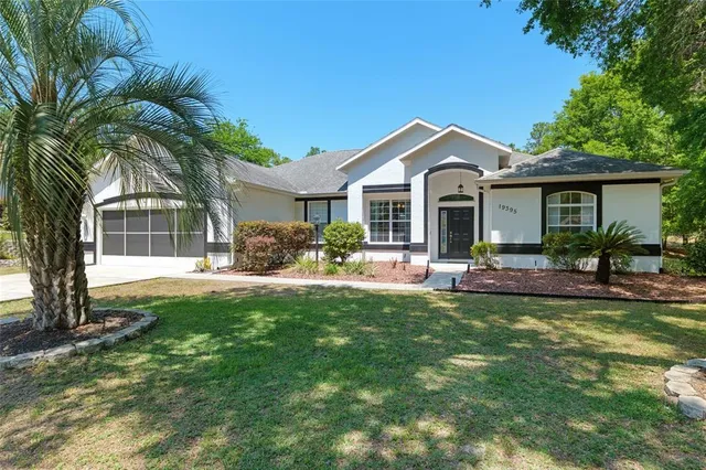 a front view of house with a garden