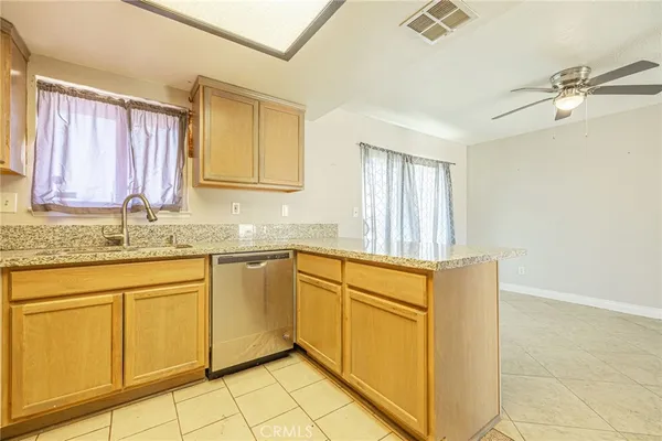 a kitchen with stainless steel appliances granite countertop a sink and cabinets