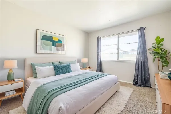 a bedroom with a bed and a window