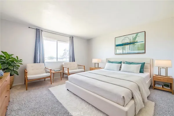 a bedroom with a large bed and a couch