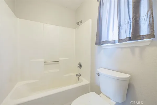 a bathroom with a toilet and a bathtub