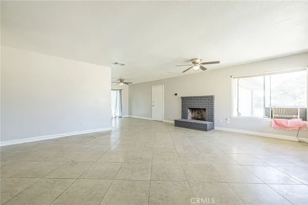 a view of a livingroom with a fireplace and a window