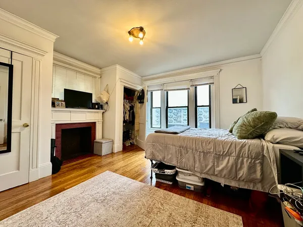 a bedroom with a bed and a fireplace