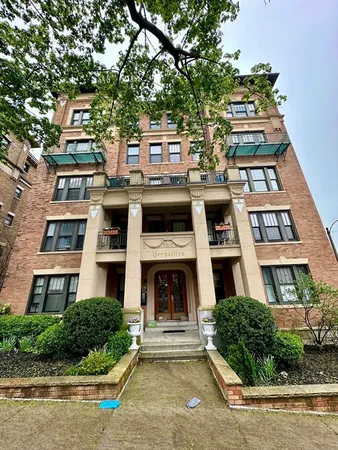 a front view of a building with a garden