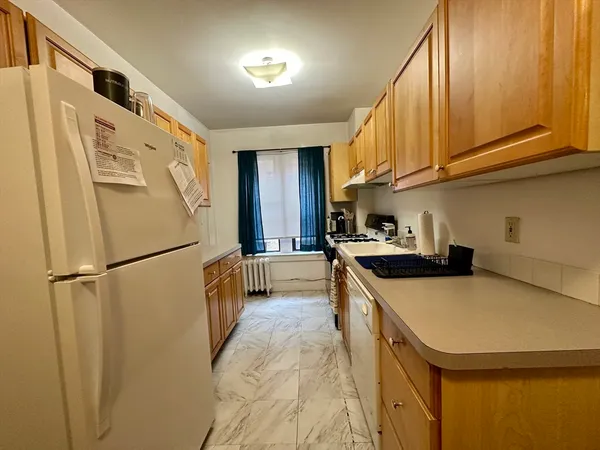 a kitchen with a refrigerator a sink and cabinets