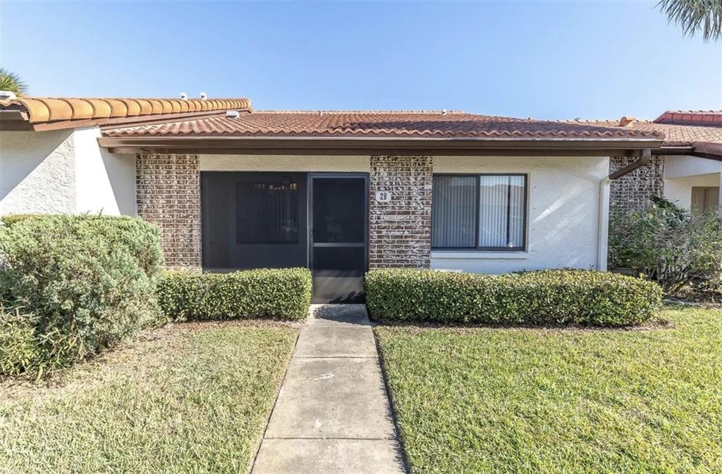 7360 Ulmerton Road, Unit 2B Largo, FL 33771 - Photo 2 of 15 a front view of a house with a garden