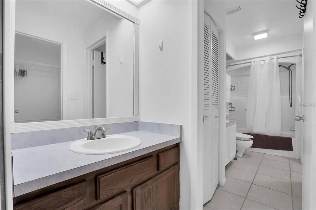 7360 Ulmerton Road, Unit 2B Largo, FL 33771 - Photo 4 of 15 a bathroom with a sink a toilet and shower