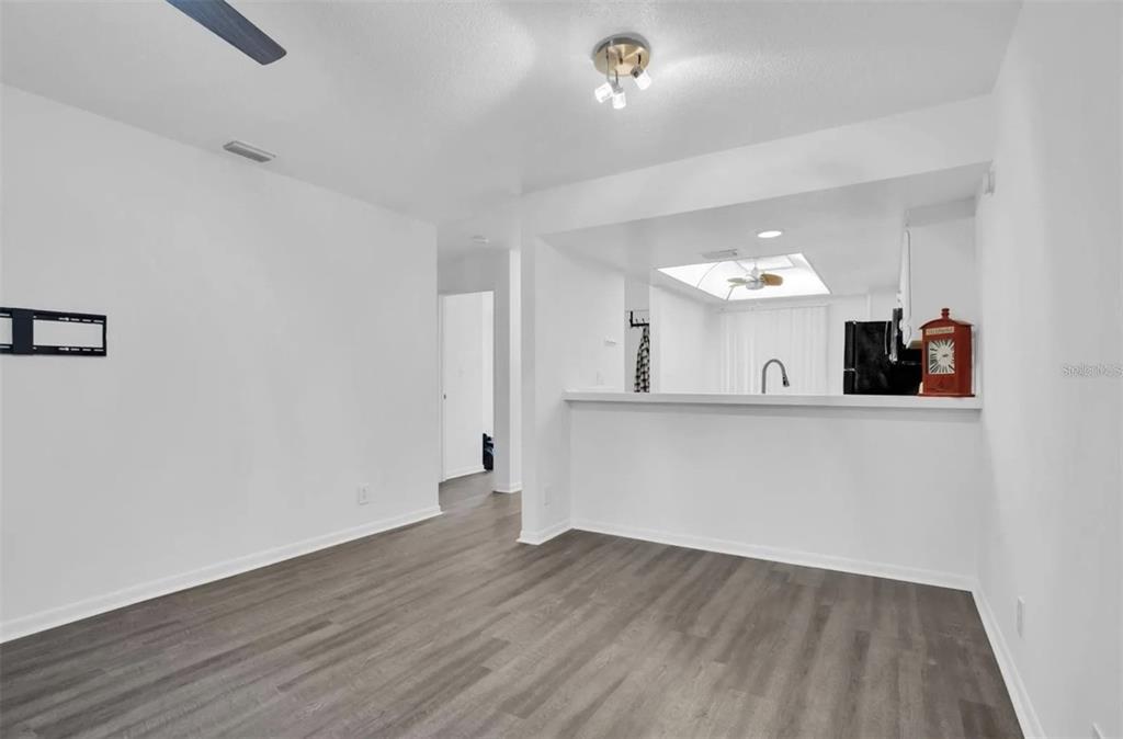 7360 Ulmerton Road, Unit 2B Largo, FL 33771 - Photo 10 of 15 a view of a kitchen with wooden floor and a sink