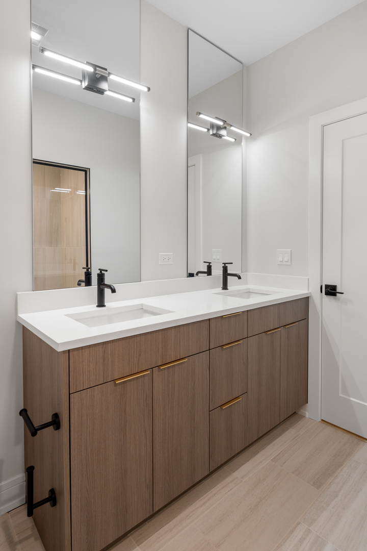 5008 South Prairie Avenue Chicago, IL 60615 - Photo 16 of 26 a bathroom with a double vanity sink and mirror