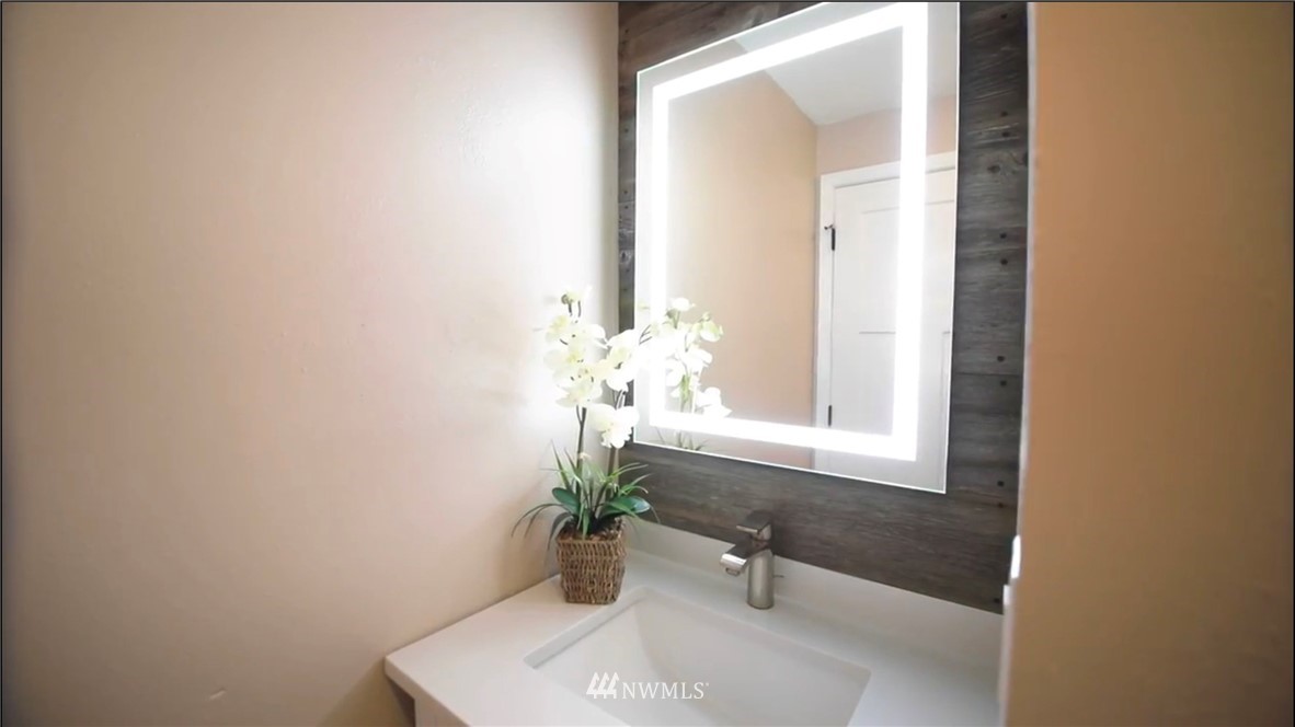 908 North 33rd Street Renton, WA 98056 - Photo 11 of 22 a bath room with a sink and a mirror